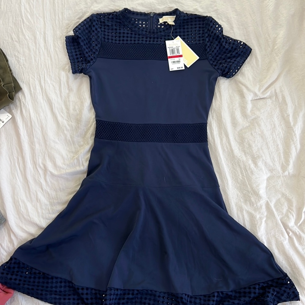 Brand new. Never worn. Michael Kors navy dress in size extra small